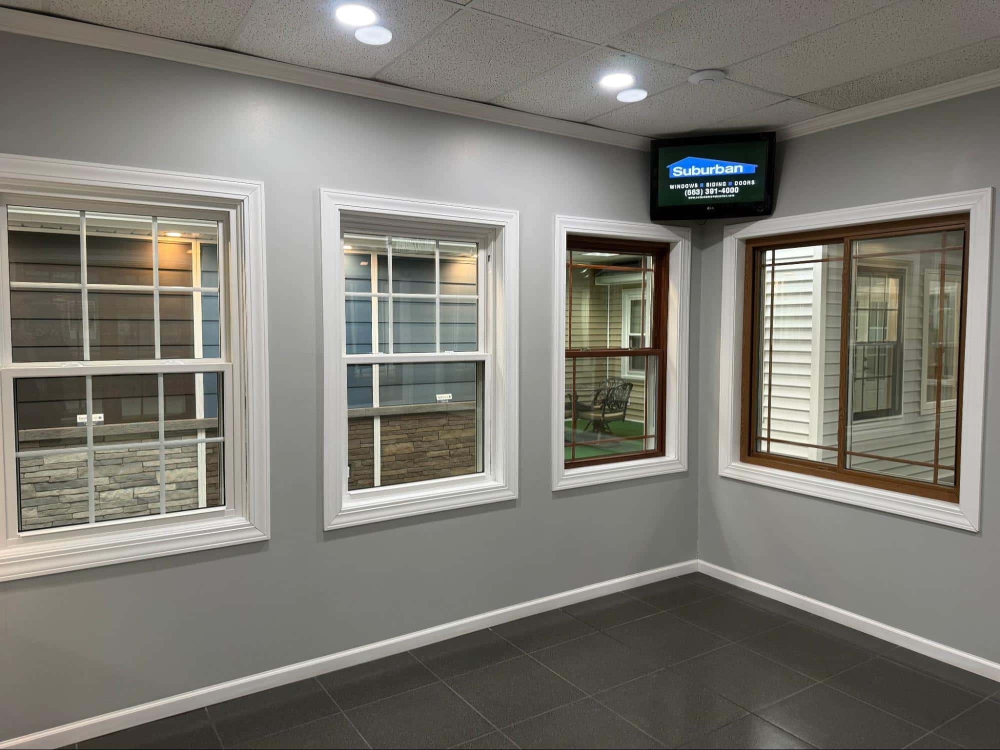 Suburban Construction showroom — full-scale home exterior display