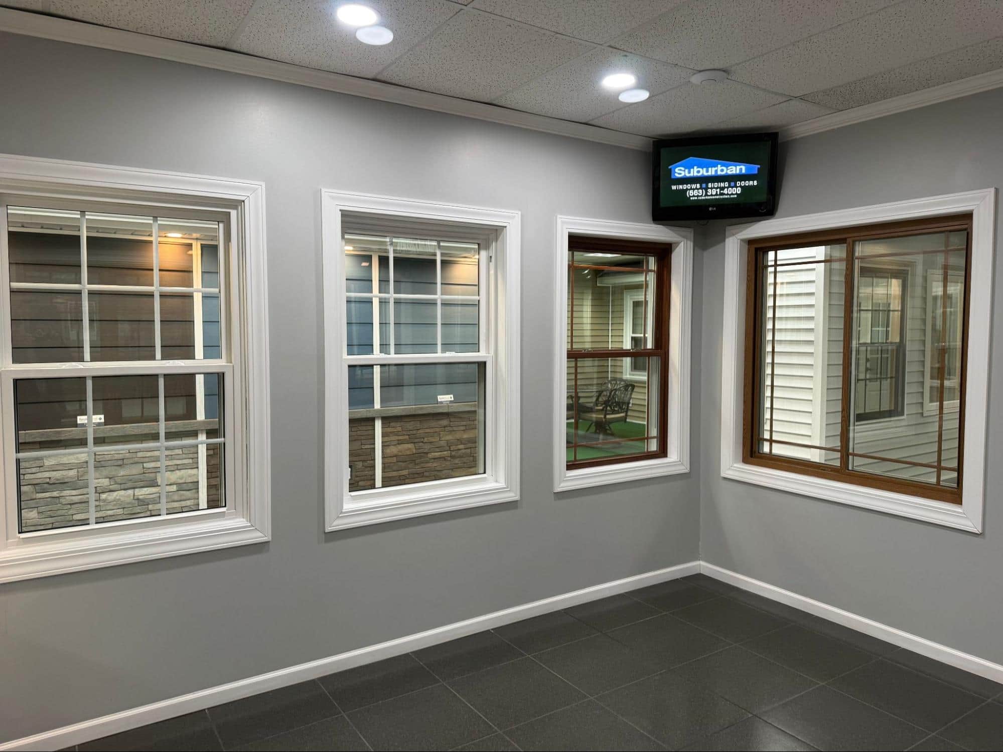 Suburban Construction showroom — full-scale home exterior display