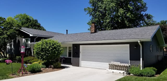 Wide seamless gutter roofline installation on a completed home