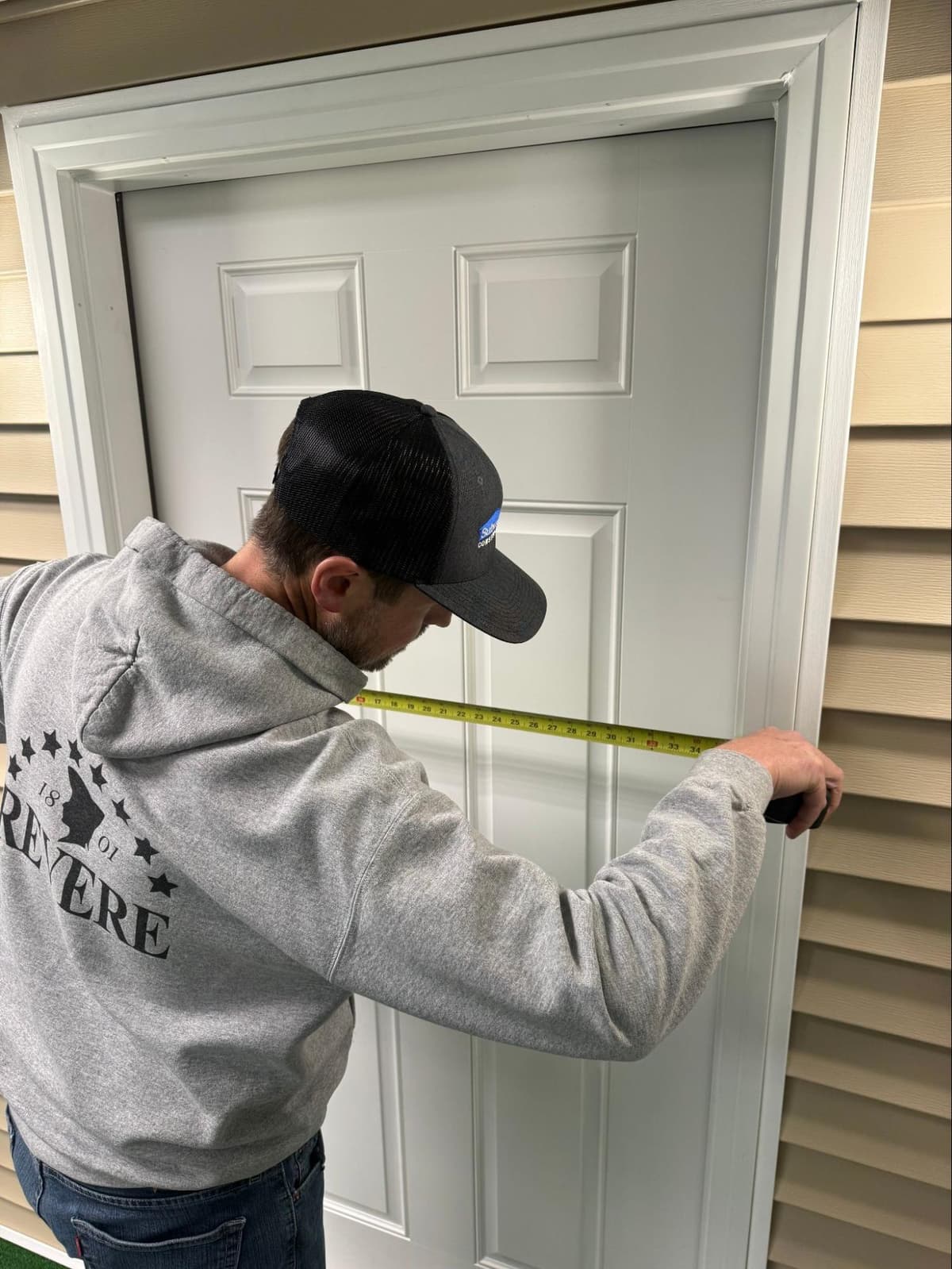 Window installation crew removing old window from home