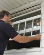 Window installer applying flashing and insulation around new window frame
