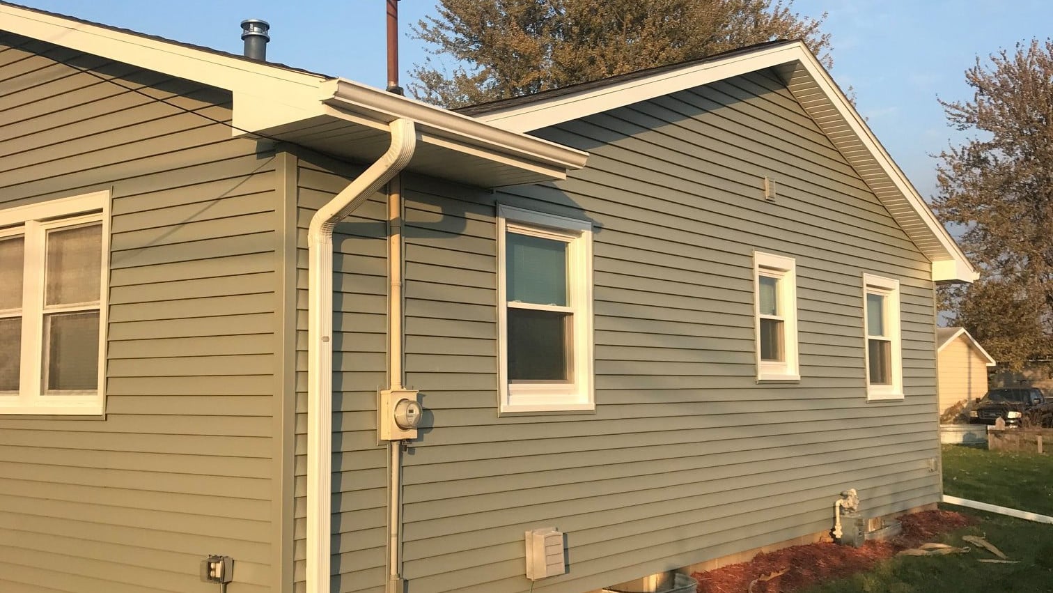 Should I replace my downspouts during a vinyl siding installation?