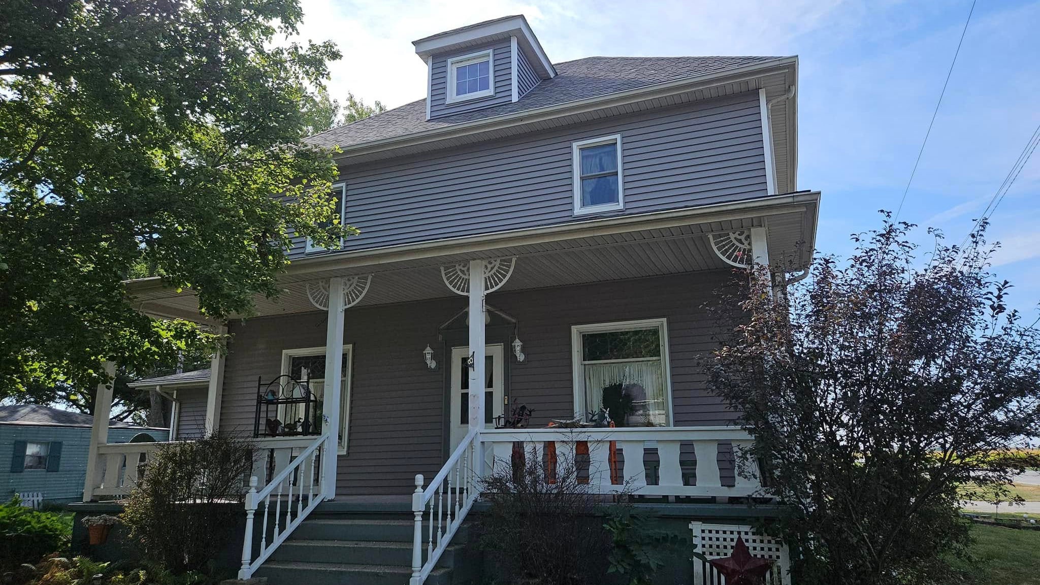 What causes green or black staining on siding?